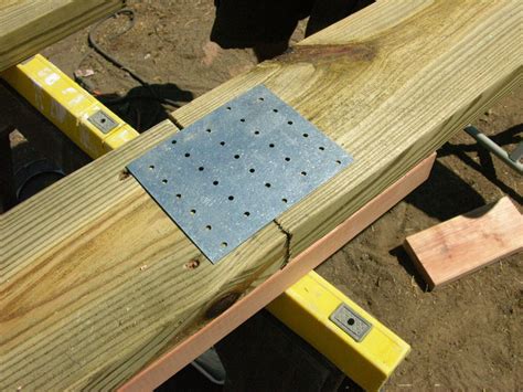 metal brackets connect lumber|brackets to hold wood together.